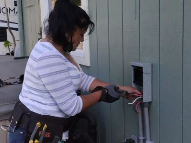 Licensed electrician wiring an exterior subpanel in Superior